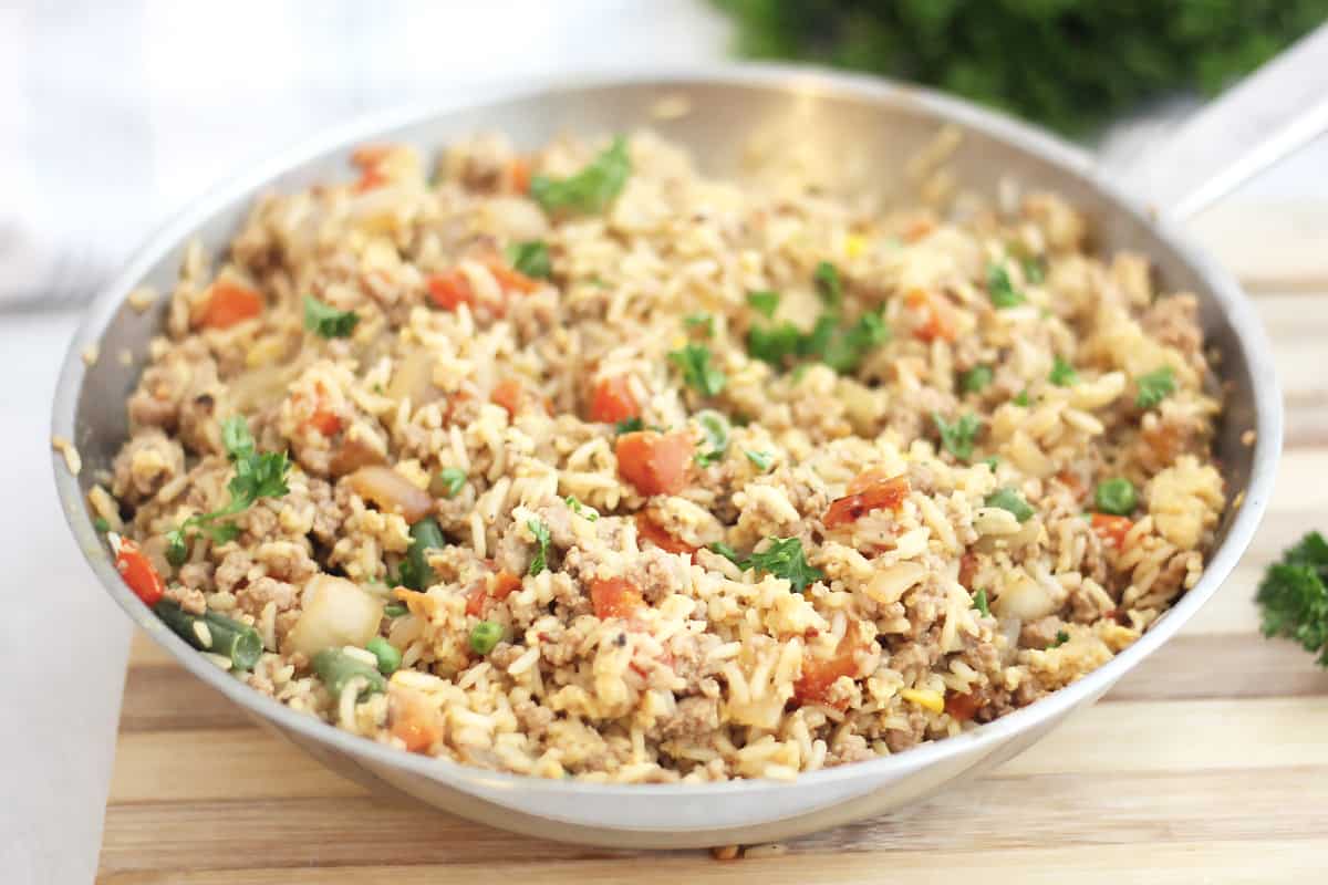 Vegetable and turkey fried rice in a skillet.