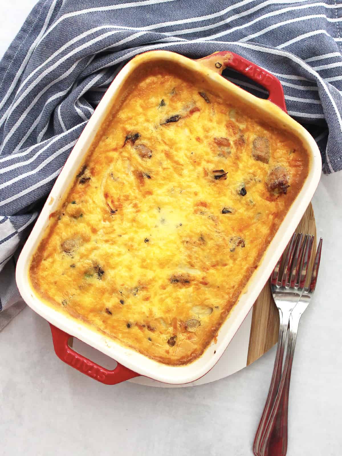 Air fryer sausage and egg breakfast casserole in a red baking dish ready to serve.