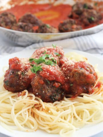 Air fryer lamb meatballs on spaghetti with tomato sauce and parmesan.