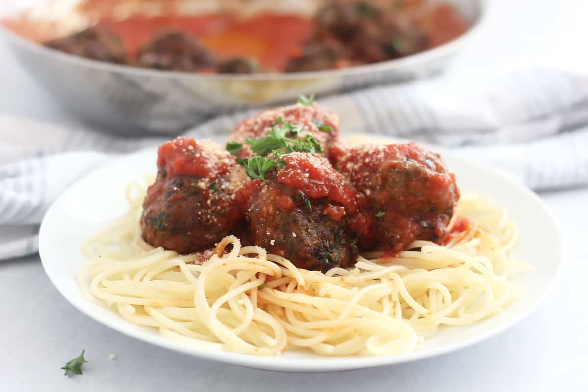 Air fried lamb meatballs served over spaghetti with tomato sauce.