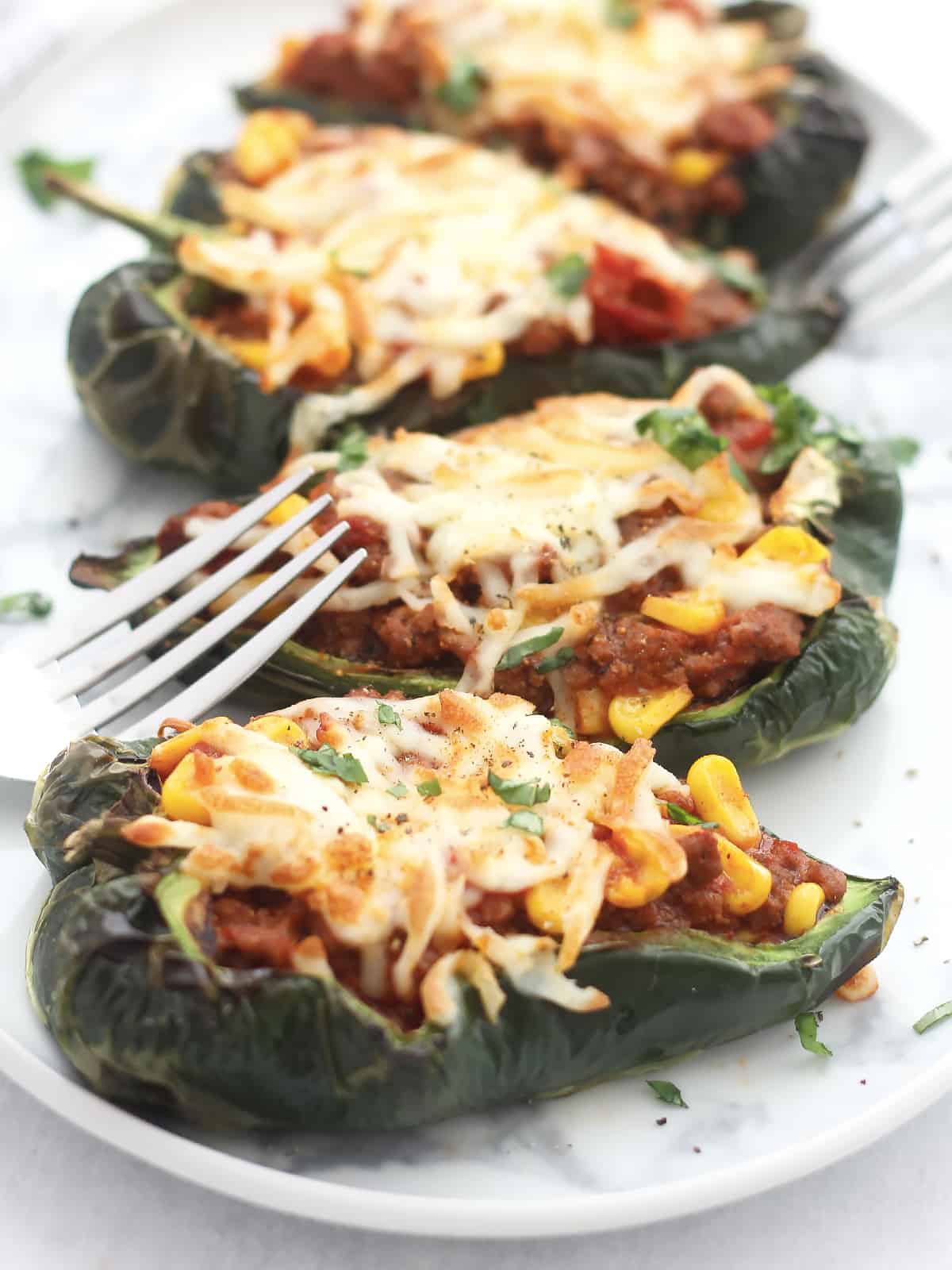 Filled poblano pepper halves topped with melted cheese.