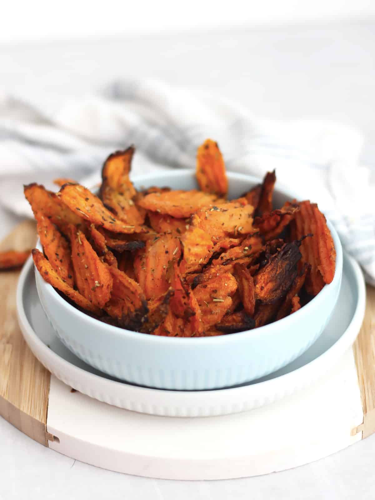 Carrot chips served in a blue bowl.
