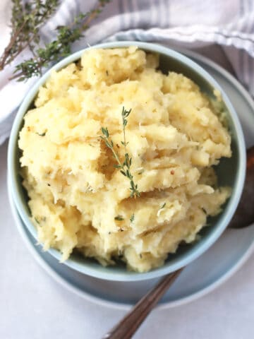 Parsnip mash garnished with sprigs of fresh thyme.