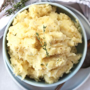 Parmesan parsnip mash topped with sprigs of fresh thyme.