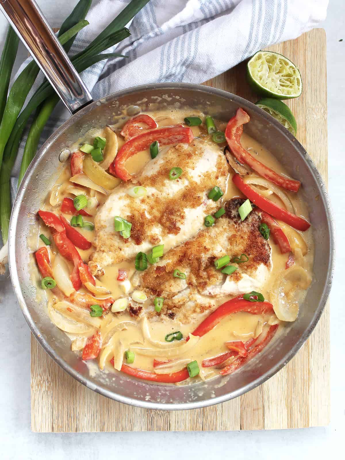 Breaded chicken and vegetables in a coconut Thai curry in a skillet.
