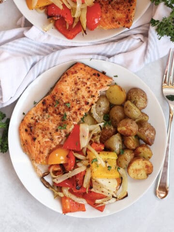 Air fried salmon, vegetables and potatoes served on a white plate.