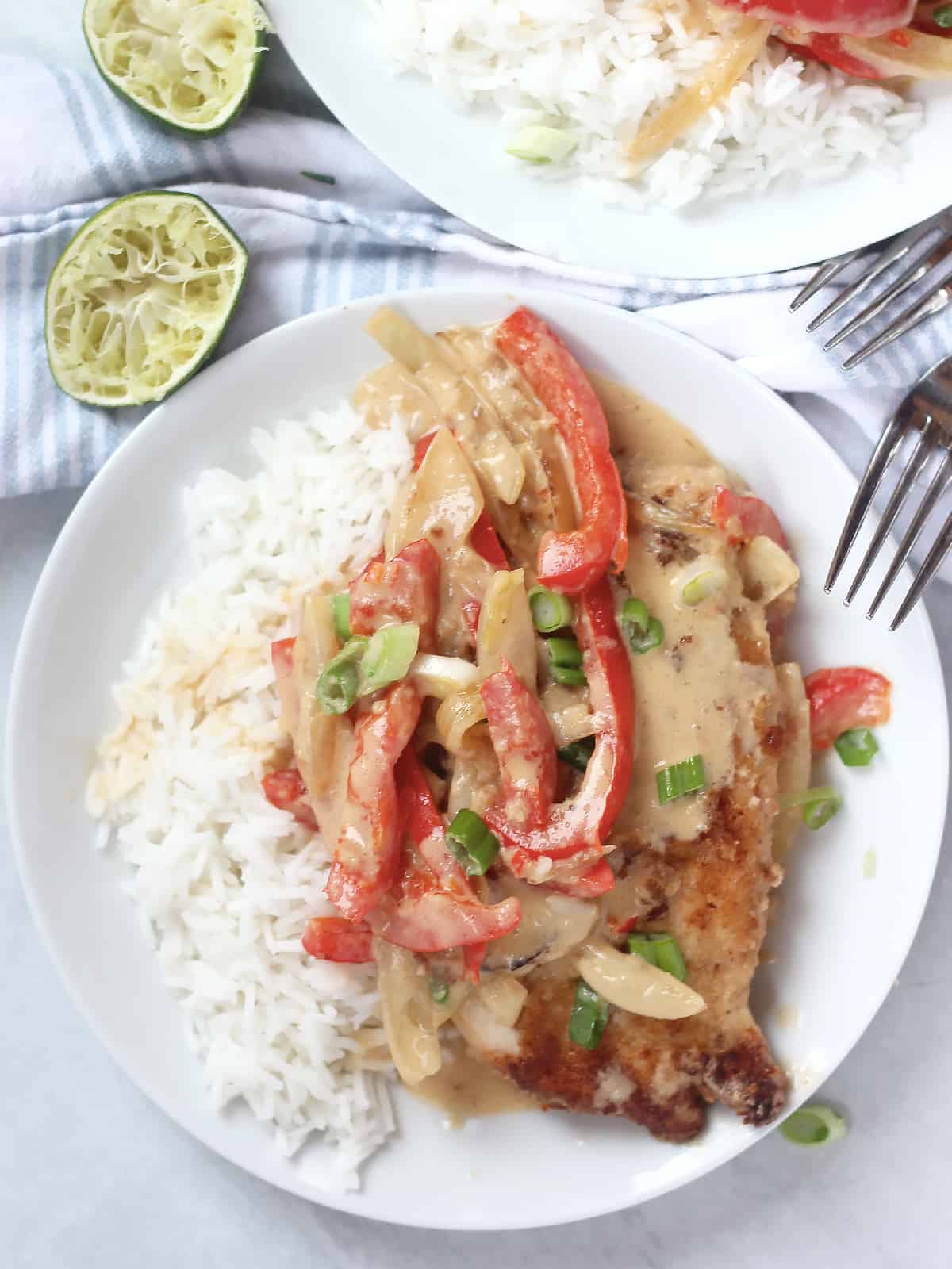 Thai chicken coconut curry served on a white plate with rice.