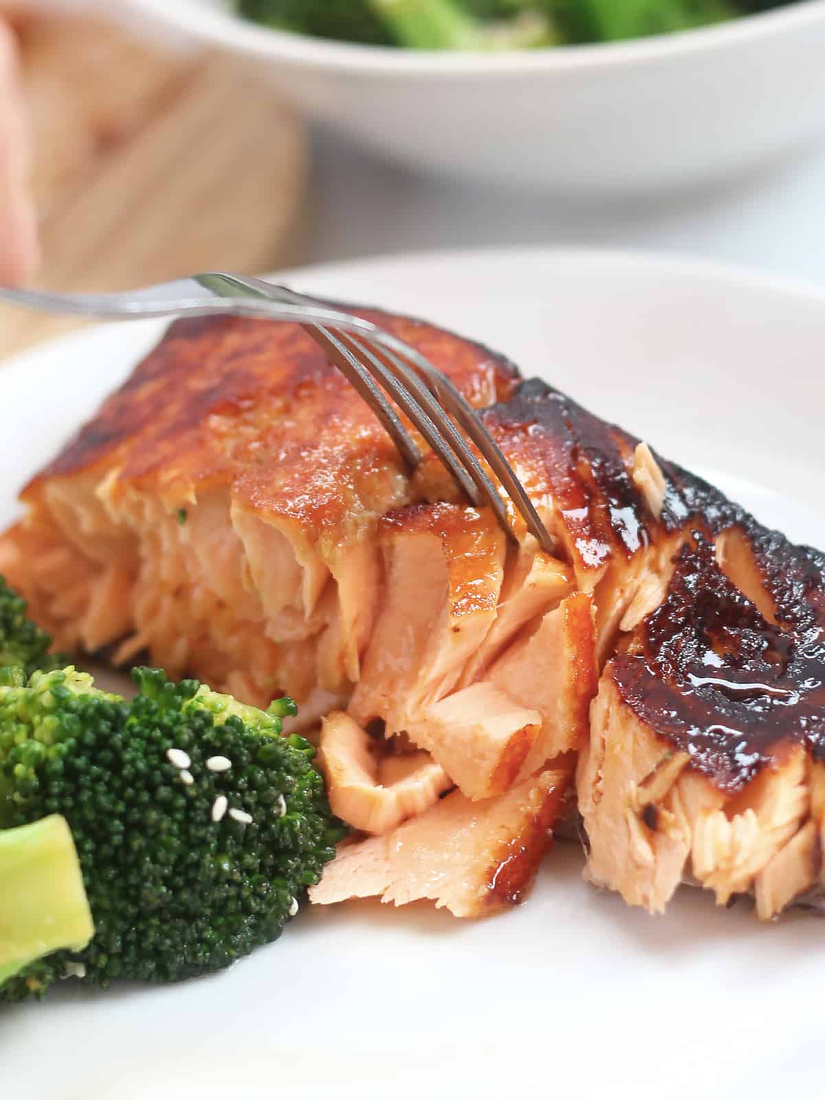 A fork flaking the air fryer salmon.