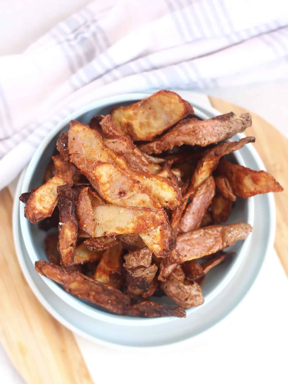 Air fried potato peelings served in a bowl.