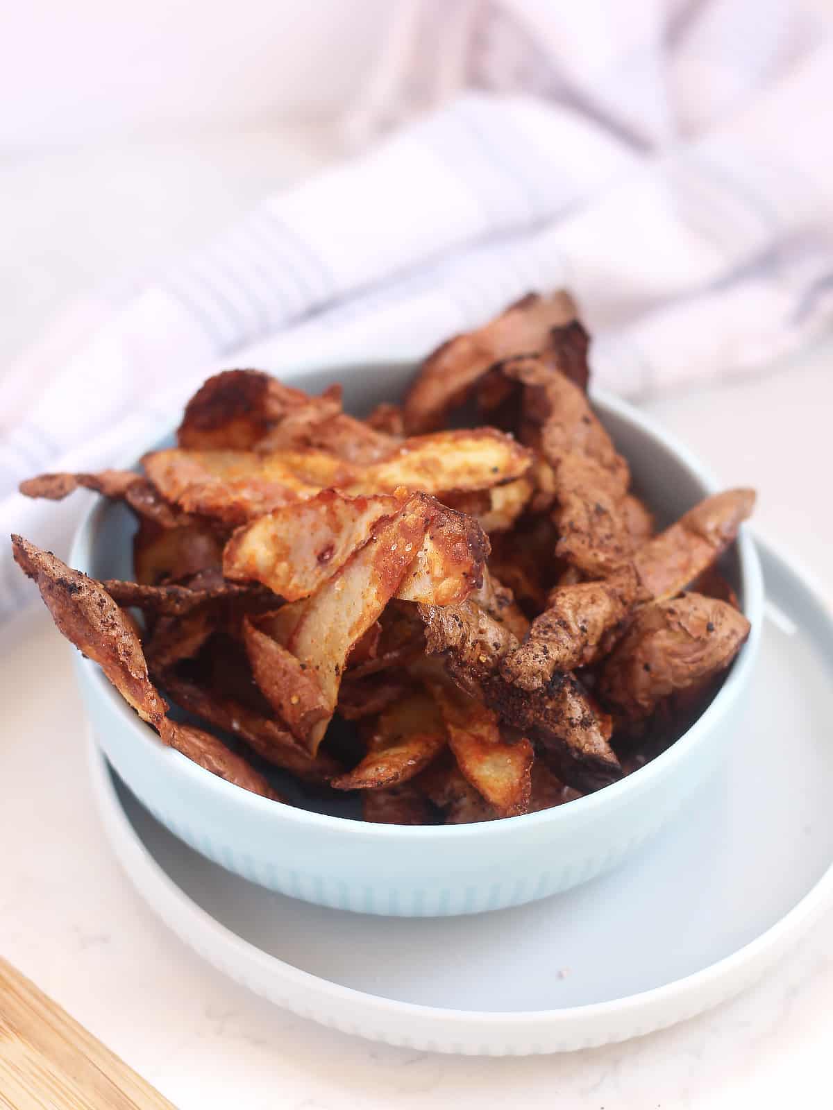 Golden brown potato chips made from peelings.