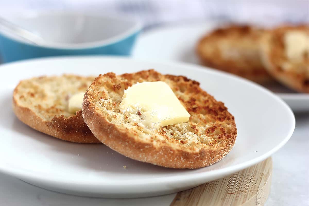 A pat of butter melting on an air fried English muffin.