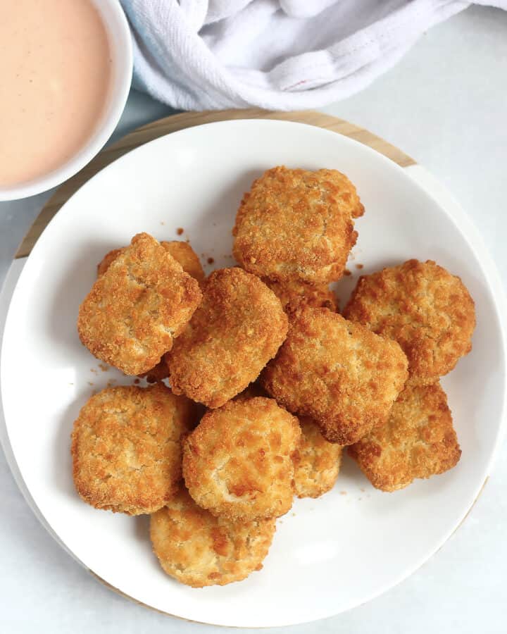 Air fryer chicken nuggets served with a dipping sauce.