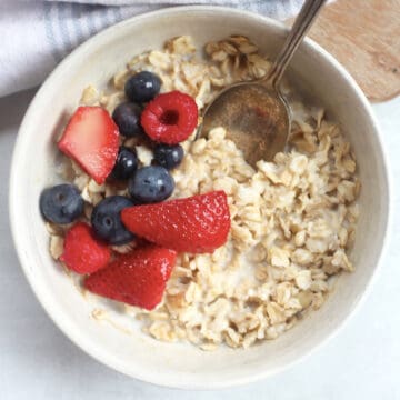 Creamy oats in milk, ytopped with blueberries, strawberries and raspberries.