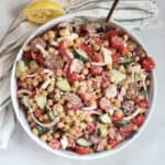 Tossed chickpea chorizo salad in a large white serving bowl.