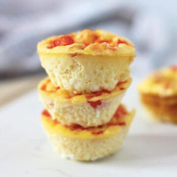 Three oven baked mini egg bites stacked on top of each other.