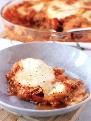 A portion of beef and cheese potato bake served in a bowl.