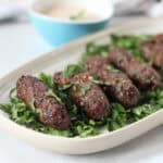 Cooked kofta kebabs on a serving plate.