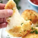 A cheese ball being pulled apart.