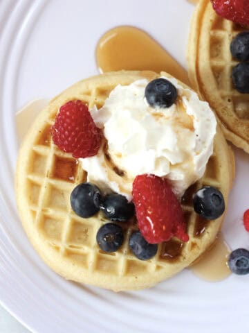 A breakfast waffle with toppings.