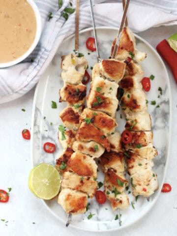 Satay chicken skewers served with peanut dipping sauce.