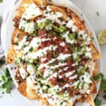 Chili beef nachos topped with guacamole, salsa and sour cream.