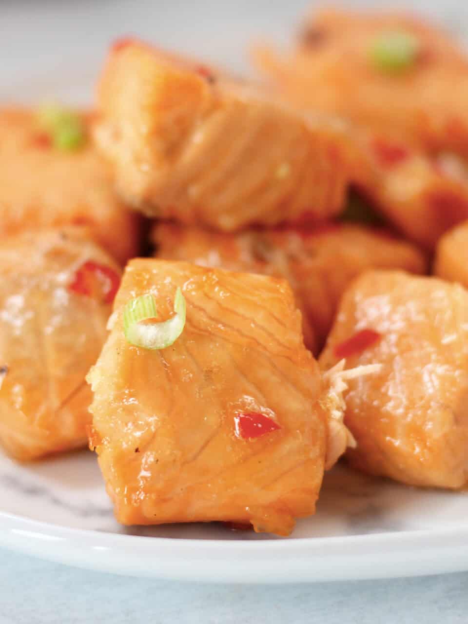 Salmon bites with honey glaze and red chili.