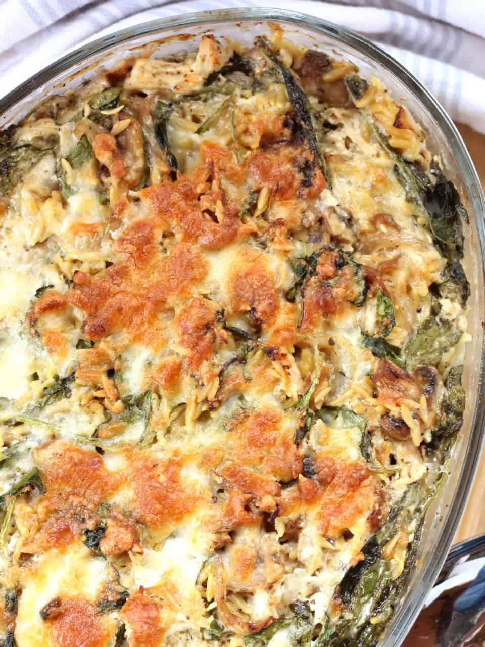 Orzo casserole with cheese topping.