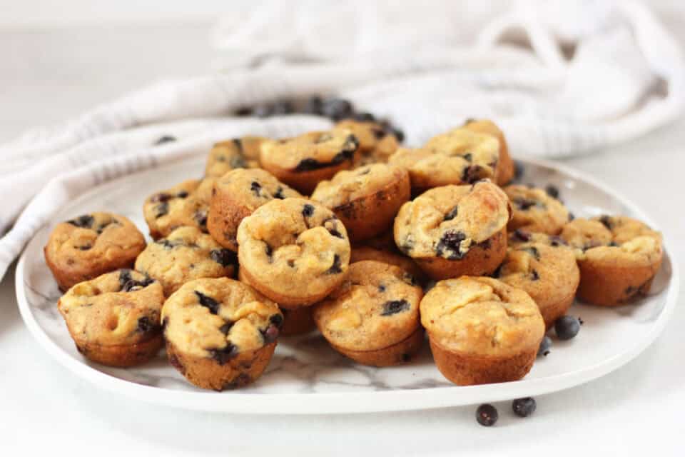 Banana blueberry mini muffins served on a plate.