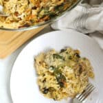 Creamy orzo pasta bake served on a white plate.