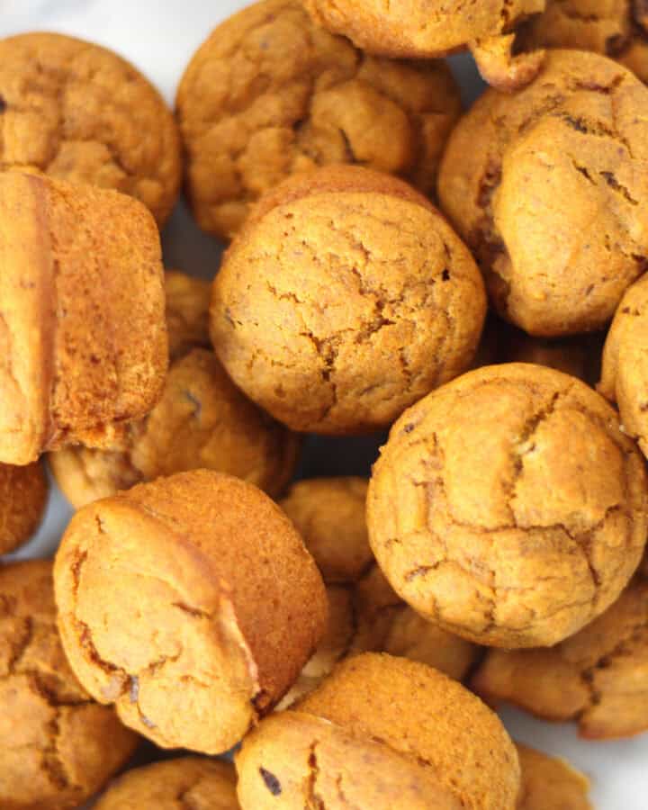 Baked muffins piled on a plate.