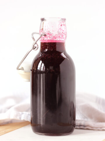 A tall bottle of blueberry simple syrup.