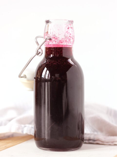 A tall bottle of blueberry simple syrup.