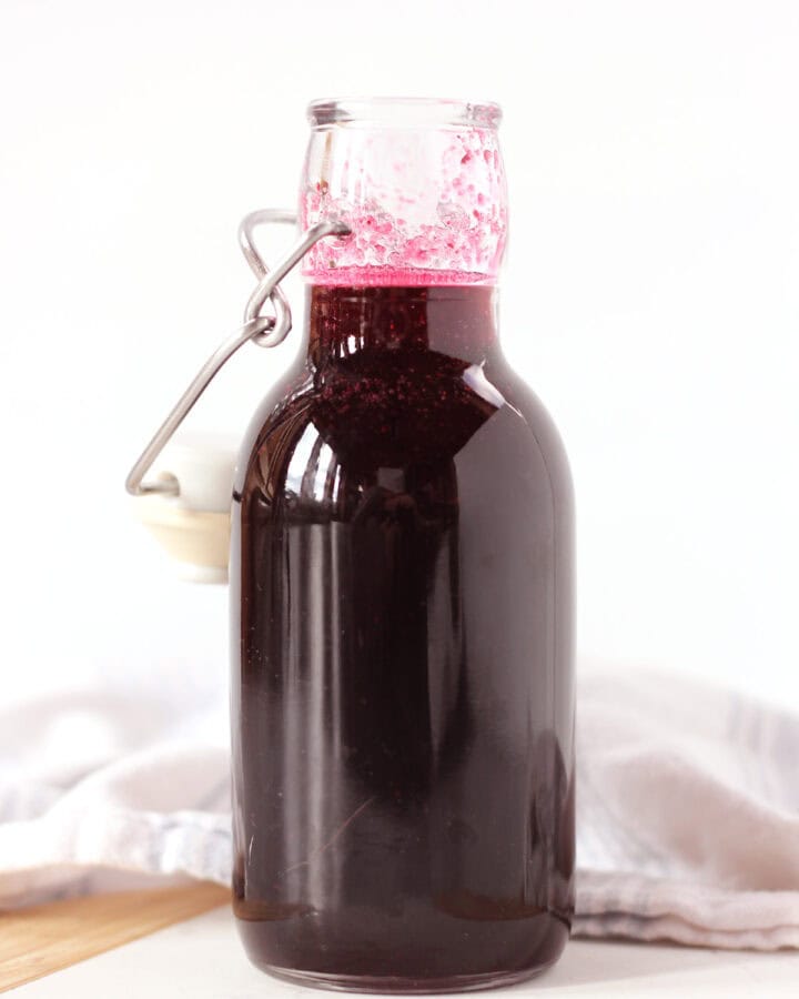 A tall bottle of blueberry simple syrup.