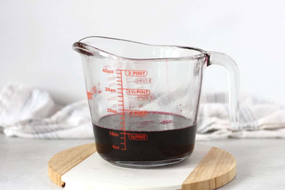 Blueberry syrup in a Pyrex measuring jug.