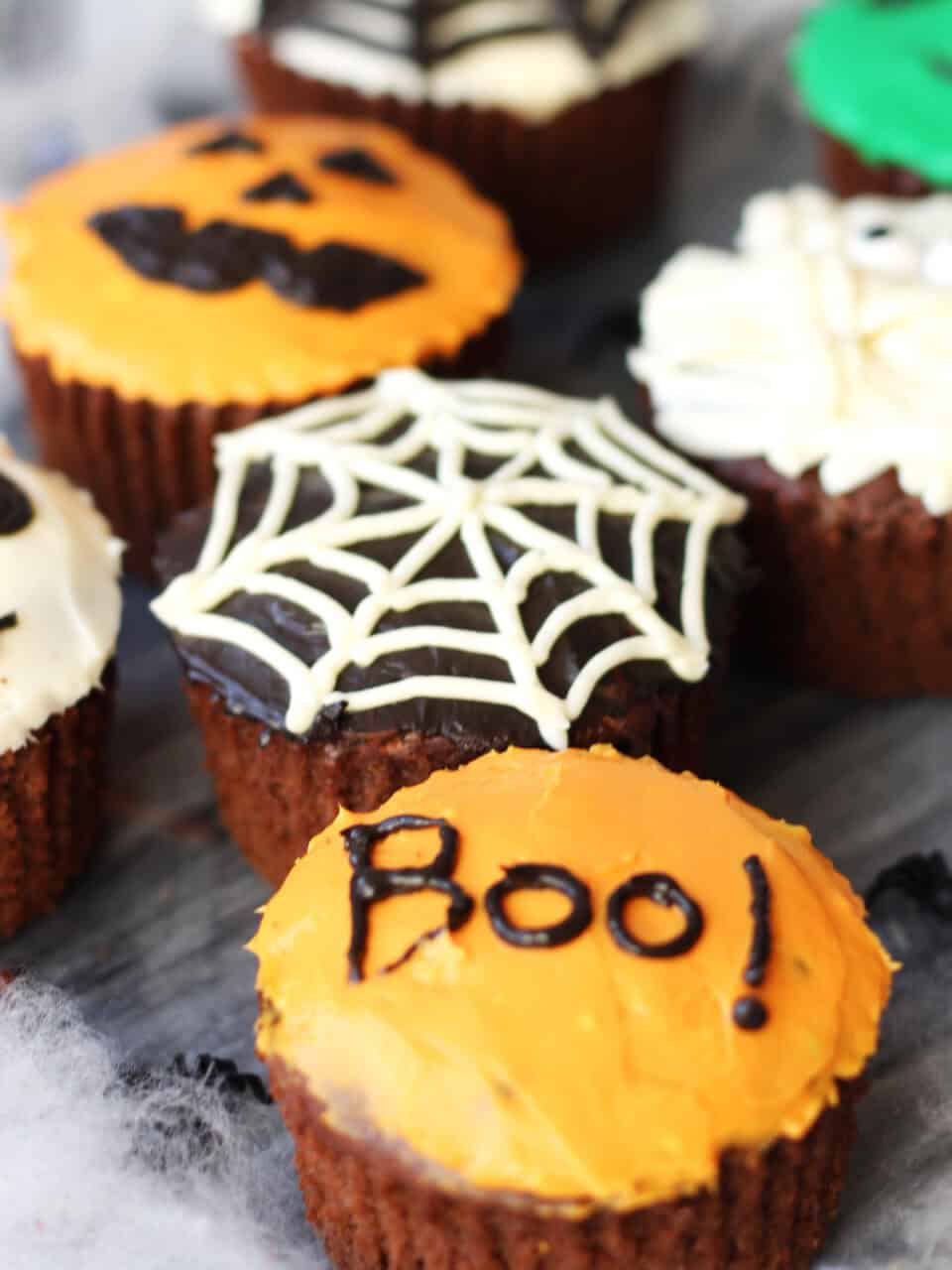 Chocolate cupcakes with cream cheese frosting decorated for Halloween.