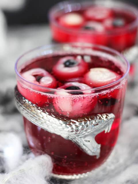 Red punch with lychee and blueberry 'eyeballs' floating in it.