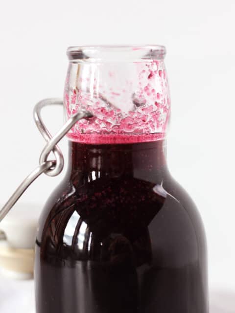 The top of a bottle of blueberry simple syrup.