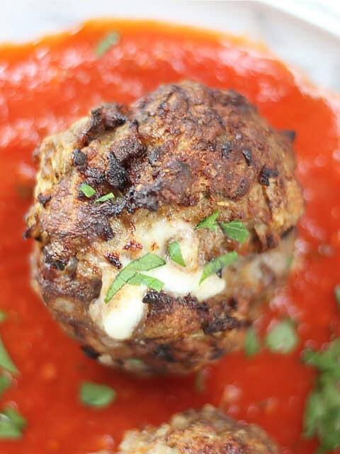 A meatball with cheese oozing out.