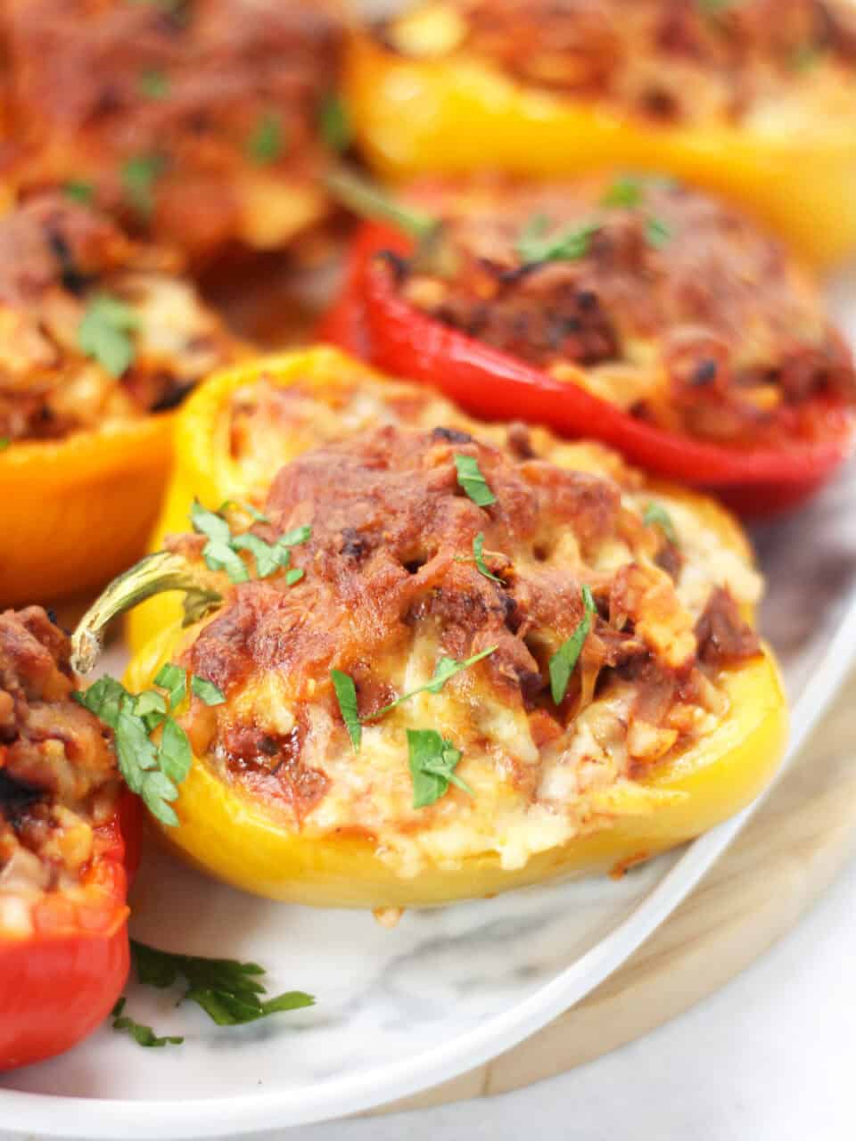 Beef and orzo stuffed peppers garnished with fresh parsley.