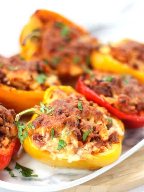 Stuffed bell peppers served on a plate.