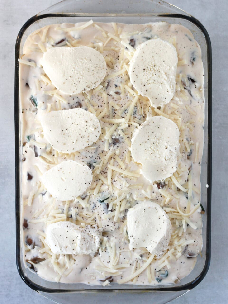 Parmesan and mozzarella cheese on top of a creamy sauce.