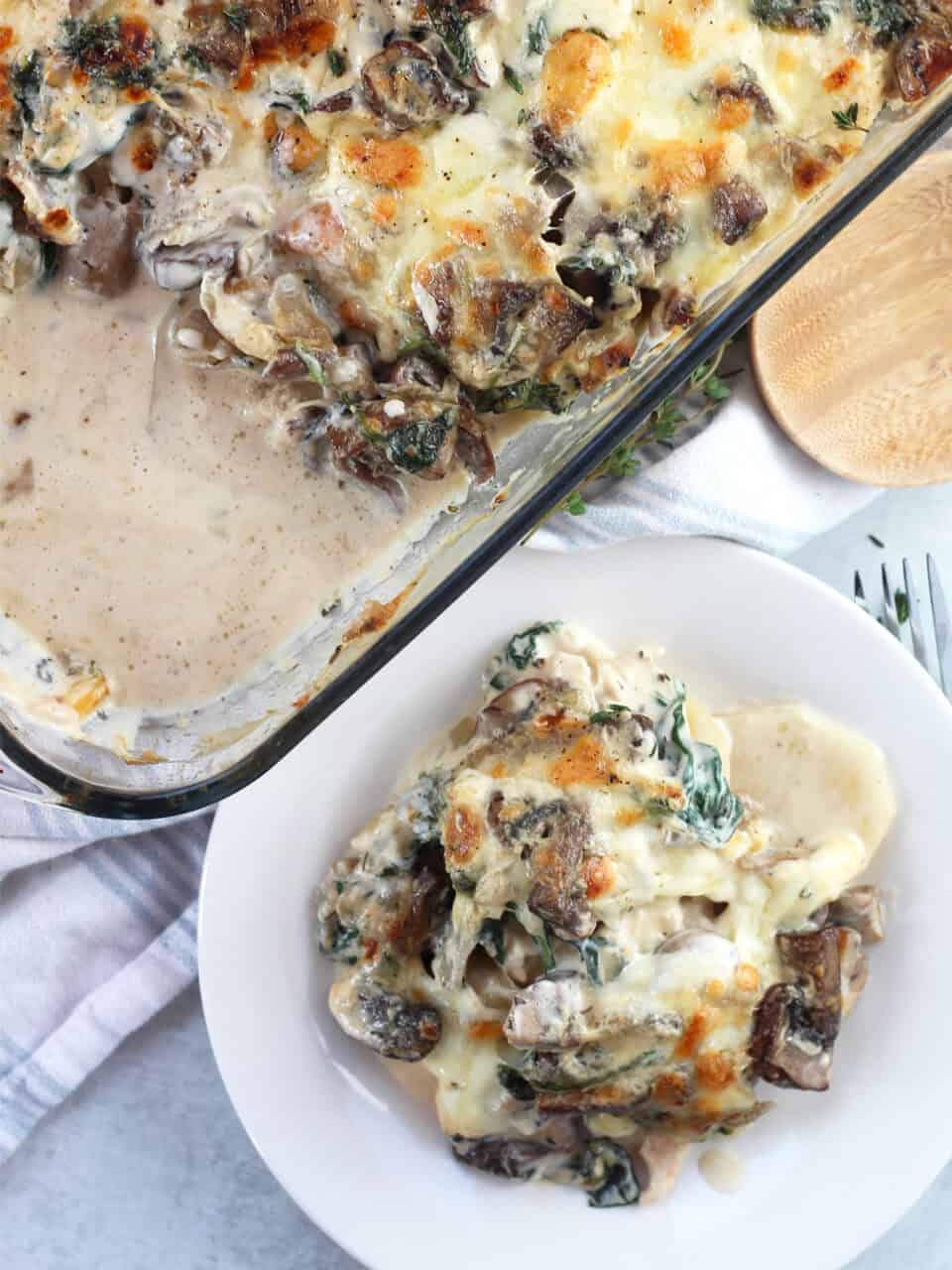 Chicken bake in a glass dish with some served onto a white plate.