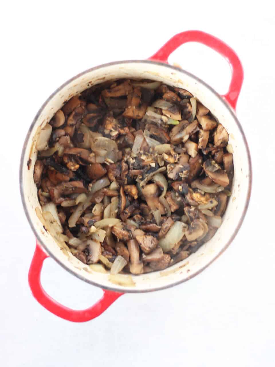 Cooked mushrooms, garlic and onions in a stock pot.