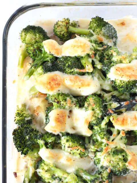 Broccoli in a creamy sauce topped with browned mozzarella cheese.