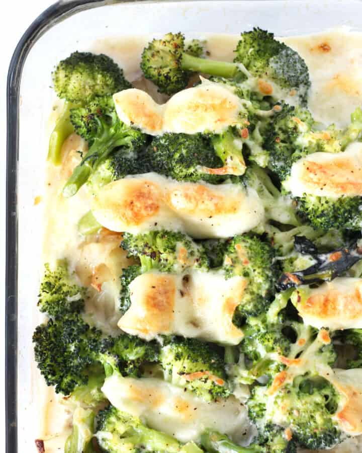 Broccoli in a creamy sauce topped with browned mozzarella cheese.