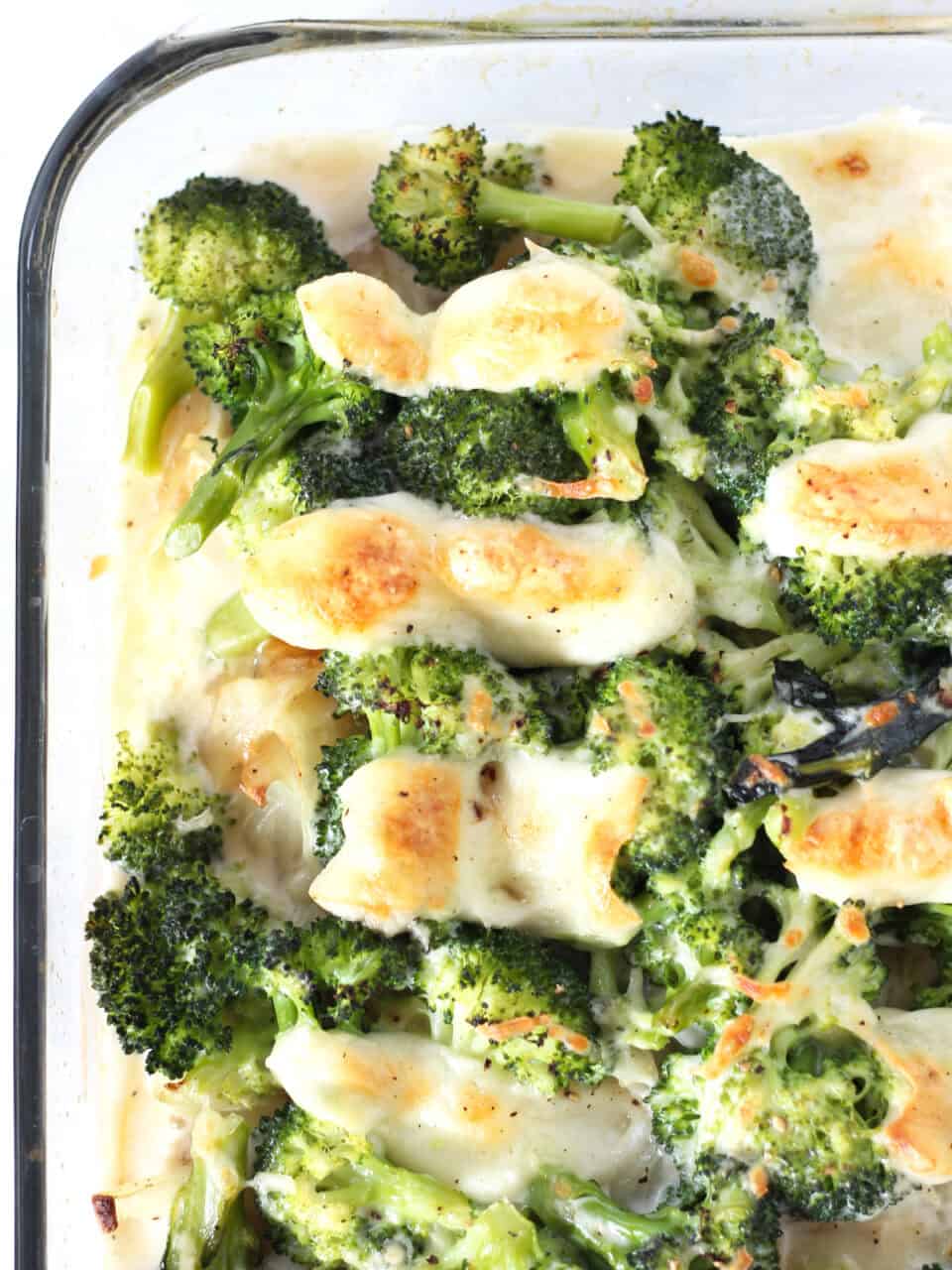 Broccoli in a creamy sauce topped with browned mozzarella cheese.