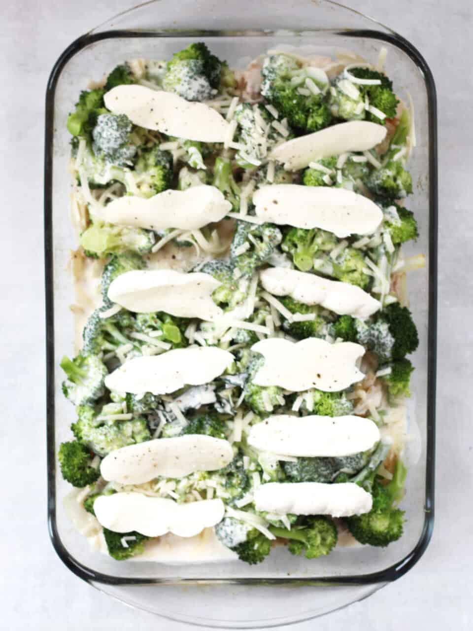 The potato bake in a glass dish before being cooked.