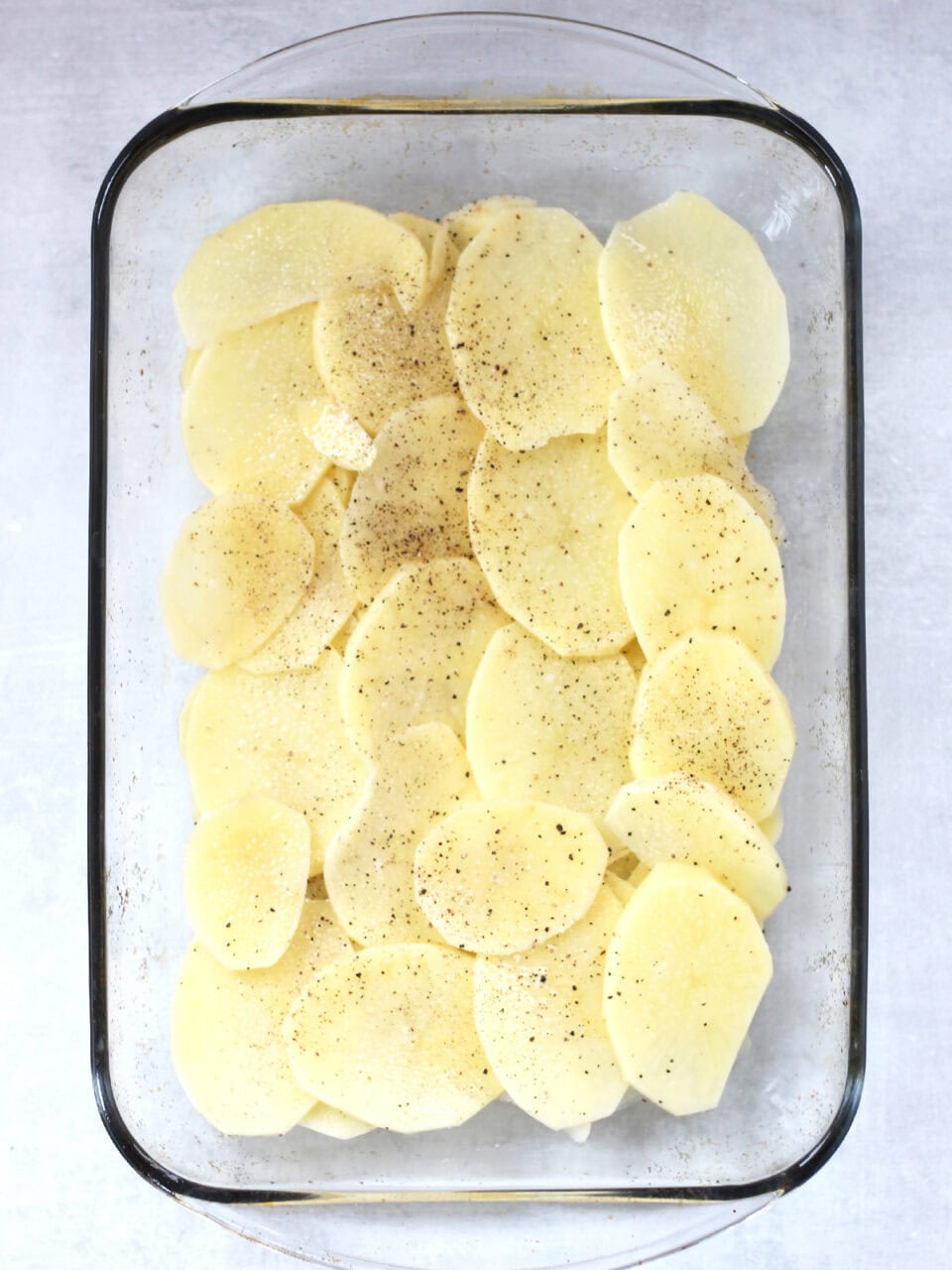 Sliced potatoes in a glass dish.