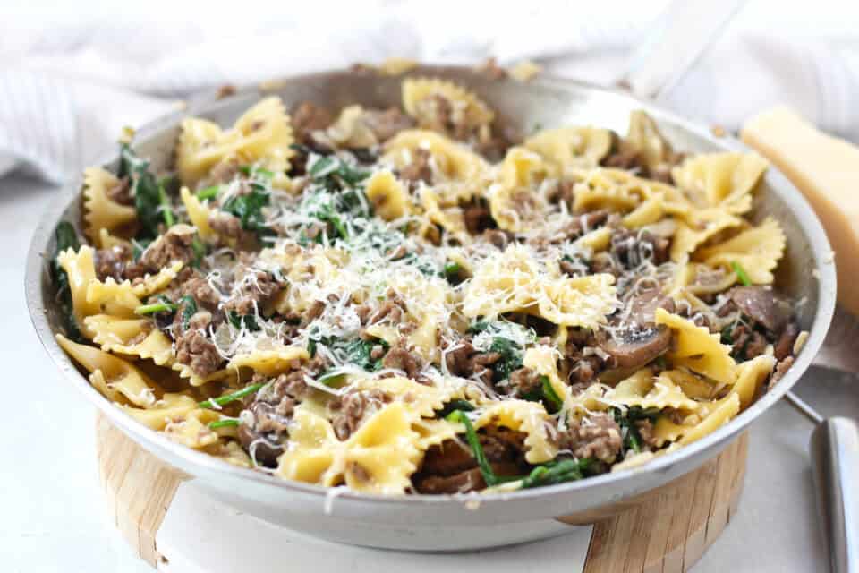 Beef, mushroom and spinach pasta topped with shredded parmesan cheese.
