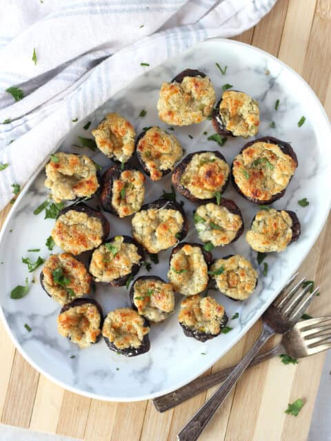 Mushrooms stuffed with blue cheese served on a plate.